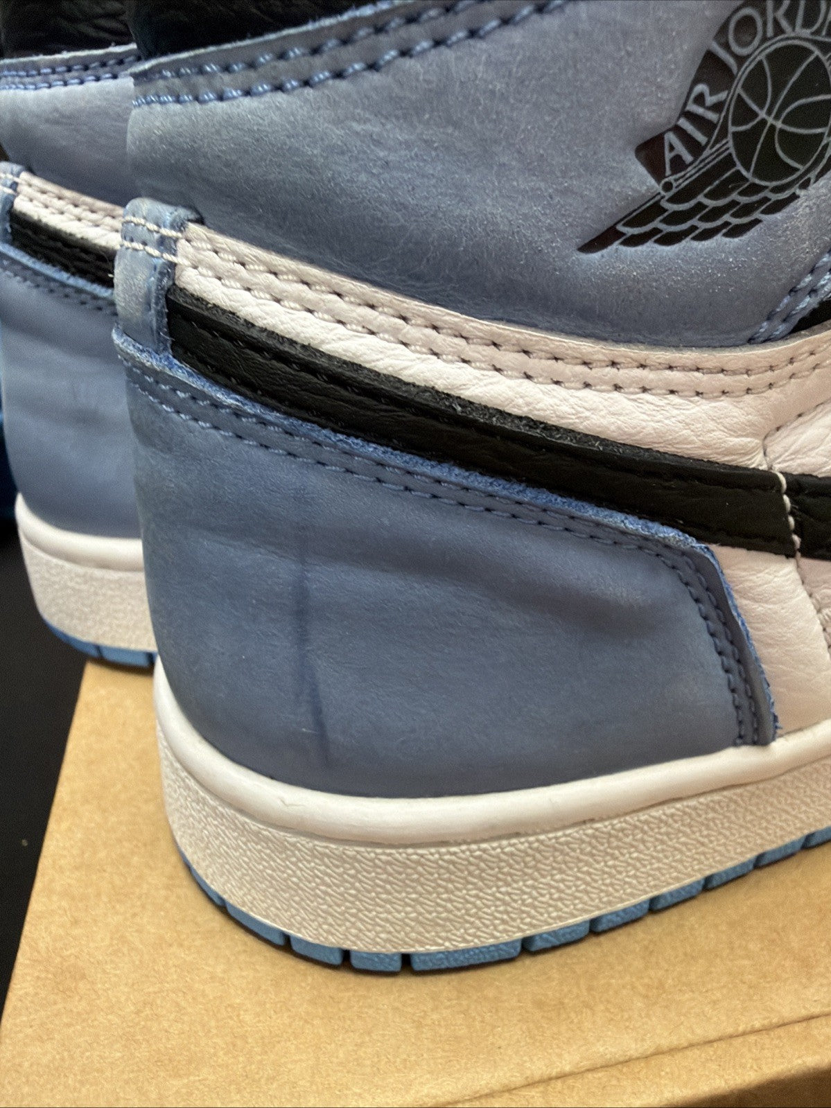 pair of Nike Air Jordan 1 Retro High OG sneakers in the "University Blue 6.5y