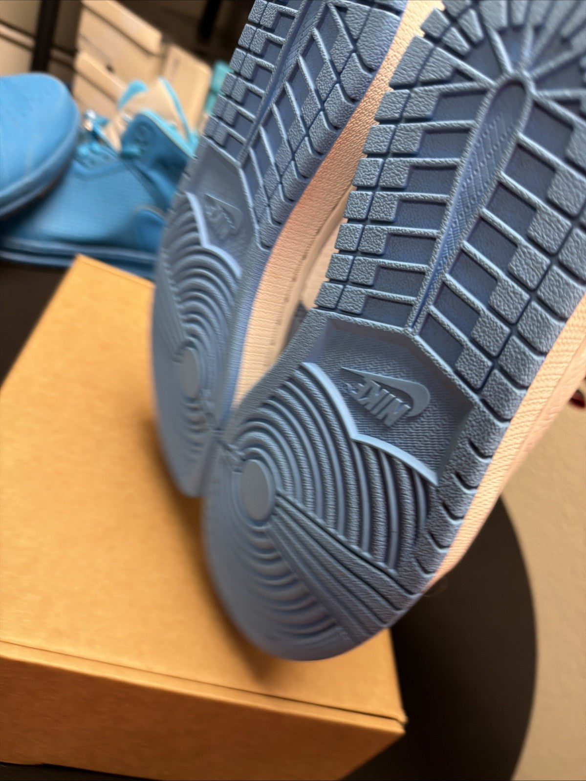 pair of Nike Air Jordan 1 Retro High OG sneakers in the "University Blue 6.5y