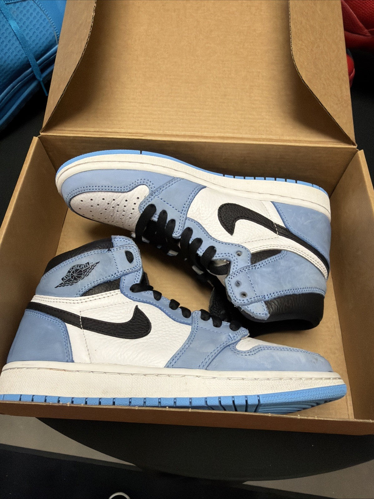 pair of Nike Air Jordan 1 Retro High OG sneakers in the "University Blue 6.5y